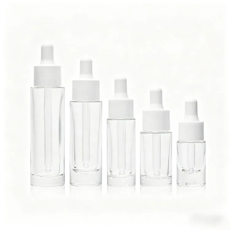 Five clear glass serum dropper bottles with white caps in different sizes